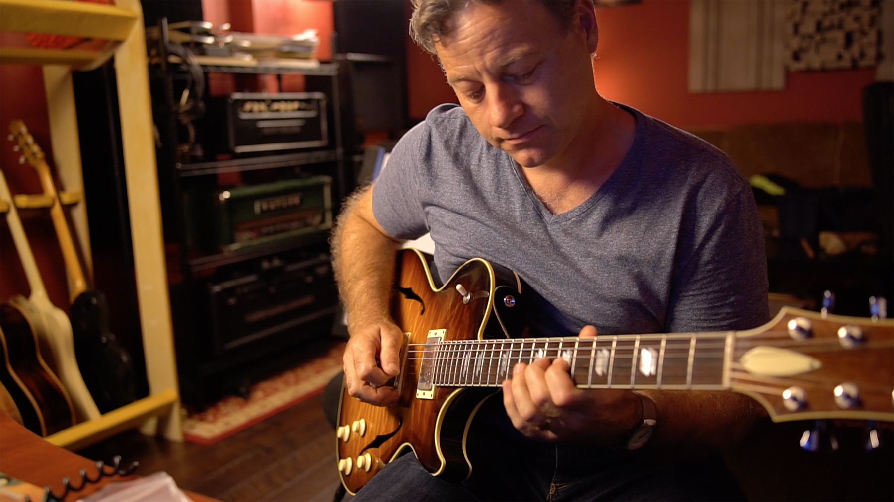 Noel Johnston playing archtop guitar in the studio